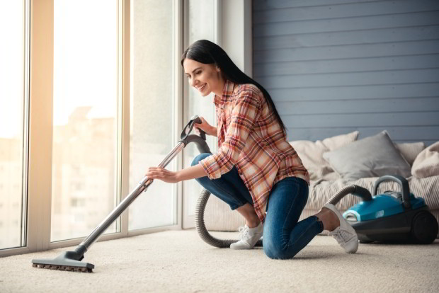 Using a vacuum cleaner while cleaning floor at home