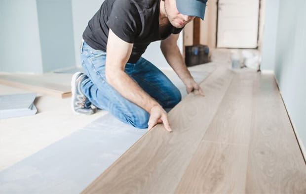 Close up of the work of a master floating flooring installation