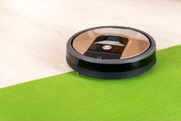 A picture showing a Roomba vacuum cleaning robot in the background