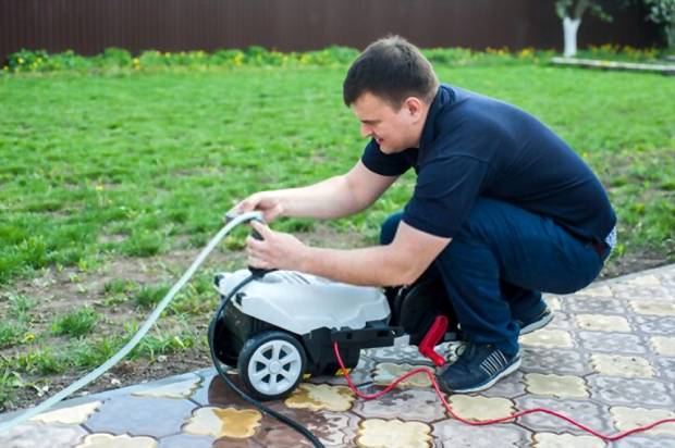 A pressure washer connected to a machine