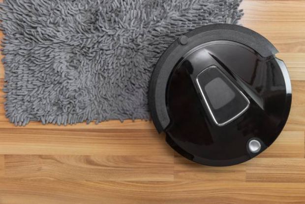 A real picture showing a vacuum cleaner on a wood floor