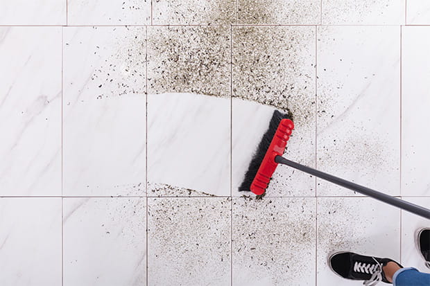 Broom Cleaning Dirt On Tiled Floor