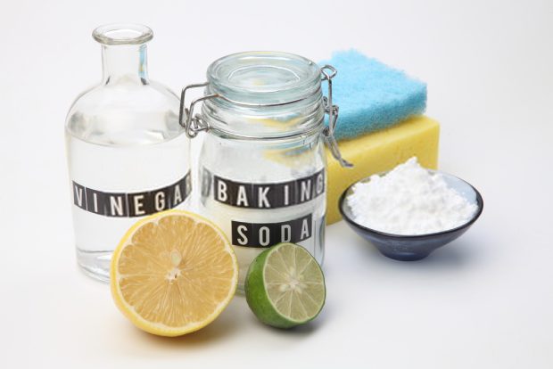 A picture of 3 simple ingredients lemon, vinegar and baking soda to make cleaning solutions