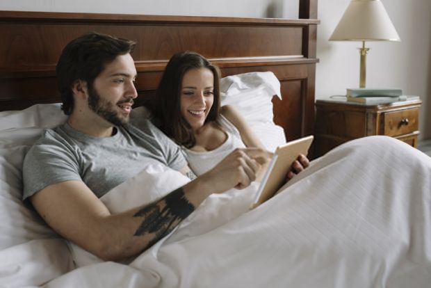 A picture showing a young couple enjoying knowing how a baby monitor works