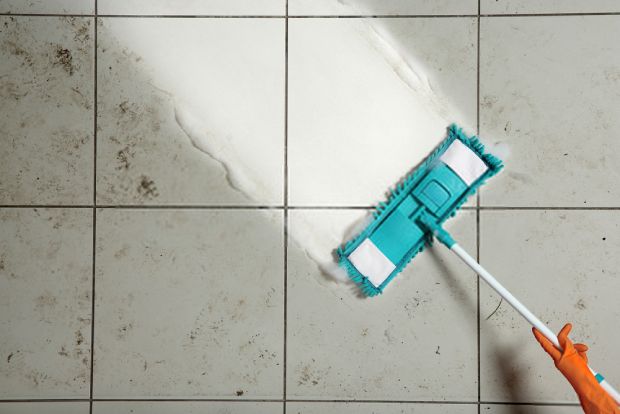 A picture showing the difference between a dirty tile floor and a clean tile floor