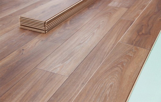 wooden laminate flooring with soundproofing sheets laying