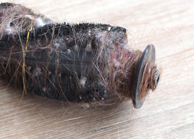 long hair wound on a vacuum cleaner brush