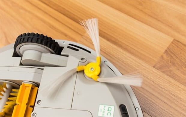 Robotic vacuum cleaner on wood parquet floor