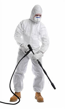 A cleaner dressed in full protective clothing before using pressure washer