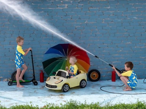 Use of a pressure washer in the wrong set up; child holding the equipment and other children playing around