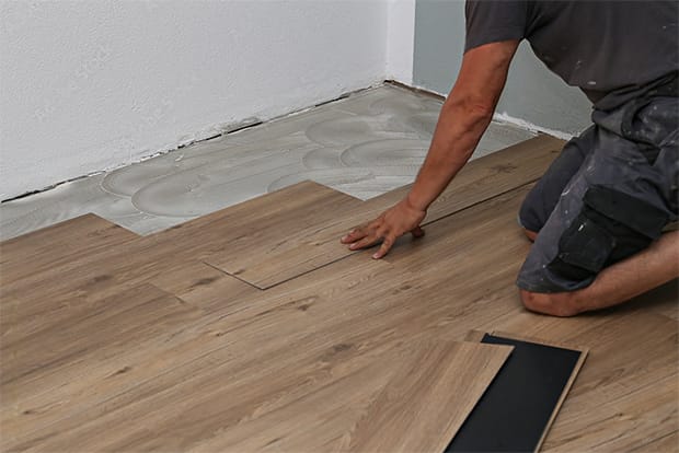 Work across the floor installing one row of vinyl planks at a time