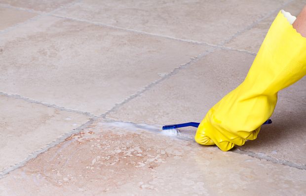 Clean tile grout with baking soda and a toothbrush